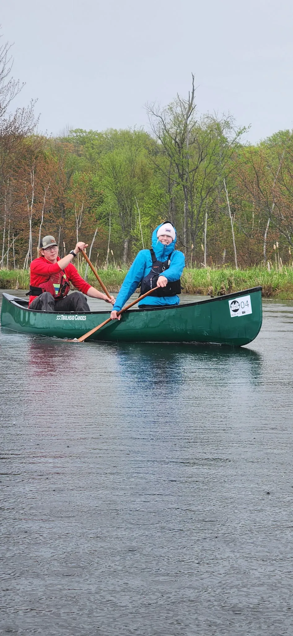 Two paddlers in a green canoe on the Rankin River during the 2026 Rankin River Canoe Rally